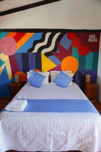 a bedroom with a large bed with a colorful wall at Samariwasi Airport hotel in Yaruqui
