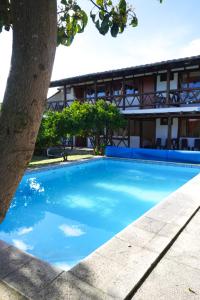 a blue swimming pool in front of a building at Samariwasi Airport hotel in Yaruqui