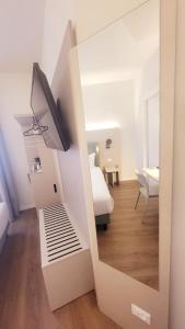 a view of a bedroom with a bed and a mirror at Hotel Aurora Duino in Duino