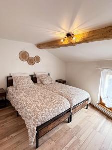 a bedroom with a bed and a ceiling fan at L'écrin des Forges maison cosy 1 à 6 voyageurs in Cousancelles +48 photos