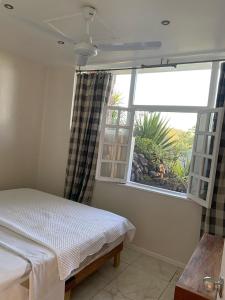 Ένα ή περισσότερα κρεβάτια σε δωμάτιο στο The Apartment at Tranquility Estate