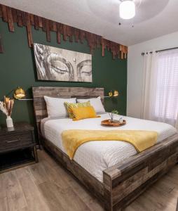 a bedroom with a large bed with green walls at Upscale Ybor House with Outdoor Living Space in Tampa +60 photos