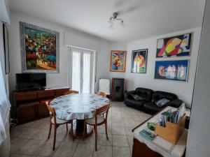 a living room with a table and a couch at Casa Nora in Dervio