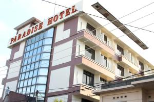 a building with a sign on top of it at Paradise Hotel in Tanjung Pinang