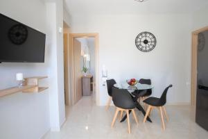a dining room with a table and black chairs at Theros Apartment 1 in Yénion
