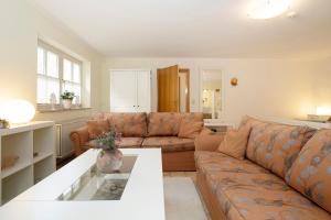 a living room with a couch and a table at Erlenstübchen in Scharbeutz