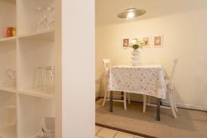 a dining room table with a vase of flowers on it at Erlenstübchen in Scharbeutz +17 photos