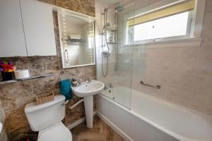 a bathroom with a toilet and a sink and a shower at Beautiful attractive house free parking near Airport in Edinburgh +18 photos
