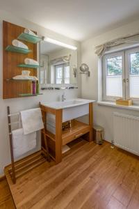 
a bathroom with a wooden floor and wooden cabinets at Hotel Rosenvilla in Salzburg
