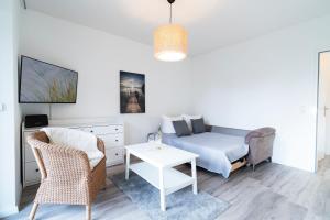 a living room with a couch and a table at Alte Bergstraße 6 Sehnsucht in Scharbeutz