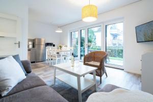 a living room with a couch and a table at Alte Bergstraße 6 Sehnsucht in Scharbeutz