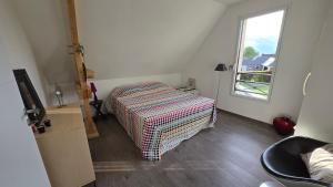 a bedroom with a bed and a window at Villa Bastilaure in Saint Pavace +4 photos