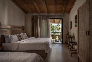 Postel nebo postele na pokoji v ubytování Bungalows Iphigenia