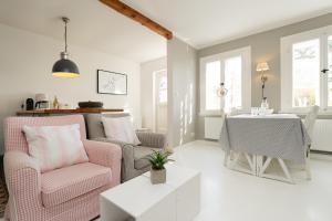 a living room with two chairs and a table at Weißes Haus 9123II in Fehmarn +31 photos