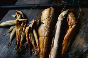 a group of fish on a wooden table at Holiday Home in Jaros awiec near Beach & Cliff in Jarosławiec +18 photos