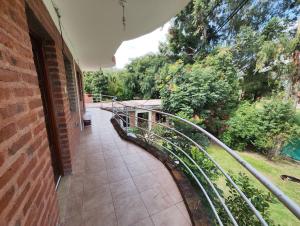 a walkway next to a brick building with a metal railing at Hostería Melodías de la Naturaleza in Yala