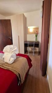 a hotel room with a bed and a desk at Casa Mariella in Sciacca