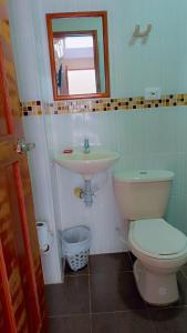 a bathroom with a toilet and a sink at Hotel Diamante in Saravena