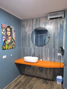 a bathroom with a sink and a mirror at Appia Apartment - Camera Fiorellino in Santa Maria a Vico +25 photos