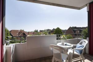 a patio with a table and chairs on a balcony at Berolina Ostseegold in Dahme