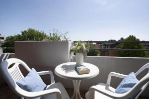 a patio with a table and chairs on a balcony at Berolina Ostseegold in Dahme +27 photos