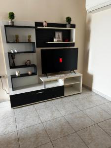 a living room with a tv on a shelf at MARIALENA HOMe in Petropiyí +20 photos