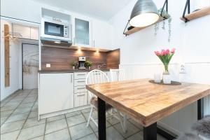 a kitchen with a wooden table in a room at Berolina Badebude 214 in Dahme