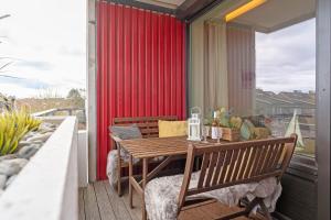 a balcony with a wooden table and chairs on a patio at Berolina Badebude 214 in Dahme