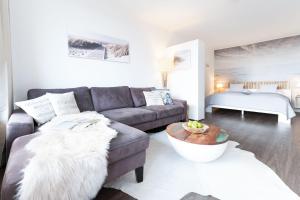 a living room with a couch and a table at Berolina Badebude 214 in Dahme +35 photos