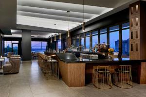a bar in a building with a view of the city at AC Hotel Savannah Historic District in Savannah