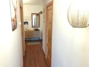 a hallway leading into a room with a mirror and a door at Benasque Valley Apartment in Bisaurri +10 photos