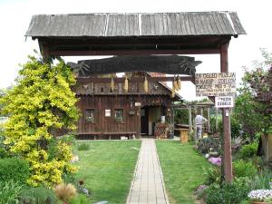 a garden with a wooden pavilion with a sign at Atera in Banovci
