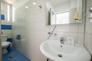 a white bathroom with a sink and a toilet at Hotel Artur2 in Ksamil +98 photos