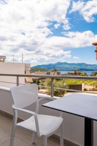 a white table and chair on a balcony with a view at Hotel Artur2 in Ksamil