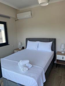 a bedroom with a large bed with two towels on it at Orkide Sapanca in Sapanca