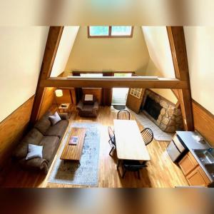an overhead view of a living room with a couch at A-Frame #06 - by The Chalets in Logan