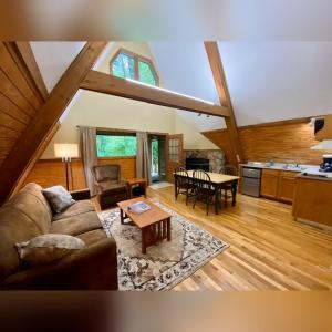 a living room with a couch and a table at A-Frame #07 - by The Chalets in Logan