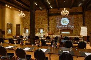 a dining room with tables and chairs and a stone wall at Boutique-Hotel & Wellness Goldenes Fass Meißen in Meißen +114 photos