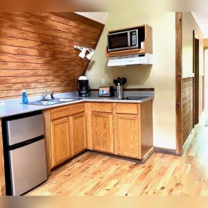 a kitchen with a sink and a microwave at A-Frame #11 - by The Chalets in Logan +15 photos