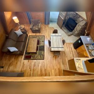 an overhead view of a living room with a couch at A-Frame #12 - by The Chalets in Logan +8 photos