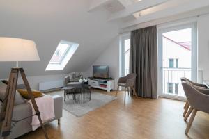 a living room with a couch and a tv at KellenHus Penthouse 2 in Kellenhusen