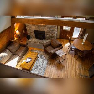 an overhead view of a living room with a fireplace at A-Frame #14 - by The Chalets in Logan