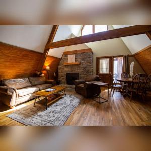 a living room with a couch and a fireplace at A-Frame #14 - by The Chalets in Logan