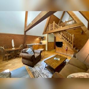 a living room with a couch and a table at A-Frame #14 - by The Chalets in Logan +14 photos