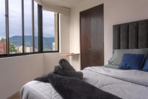 Postel nebo postele na pokoji v ubytování Apartamento en el Cable mejor zona en Manizales
