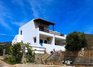 a white house with a staircase in front of it at Ateni House Garden in Agios Petros