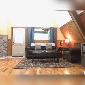 a living room with a couch and a table at A-Frame #18 - by The Chalets in Logan