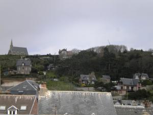 a view of a town with houses and a hill at Chambre D'hôte Villa Maurice in Étretat