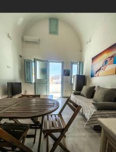 a living room with a table and a couch at Aliki's Apartments in Vóthon