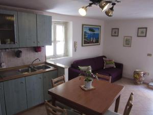 a kitchen and living room with a table and a couch at MareLuna B&B in Naples